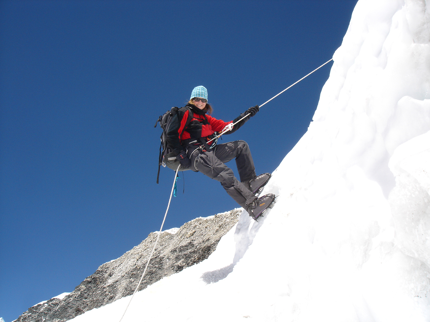 A climber abseils off the summit of Island Peak
