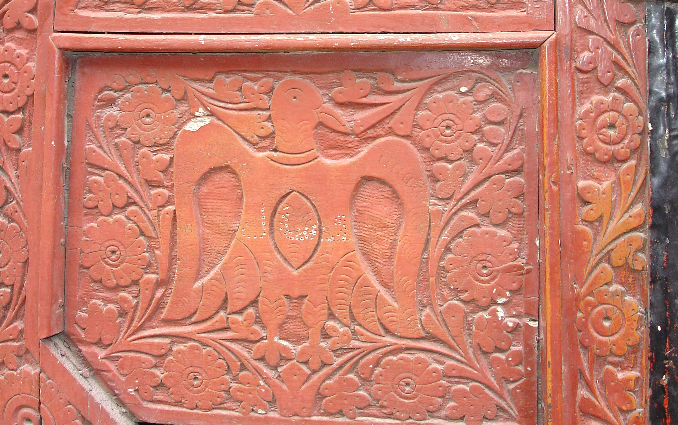 Intricate carving featuring a double-headed eagle, a really old protective motif you’ll see carved into traditional wooden architecture across northern Pakistan, especially up in the Karakoram.