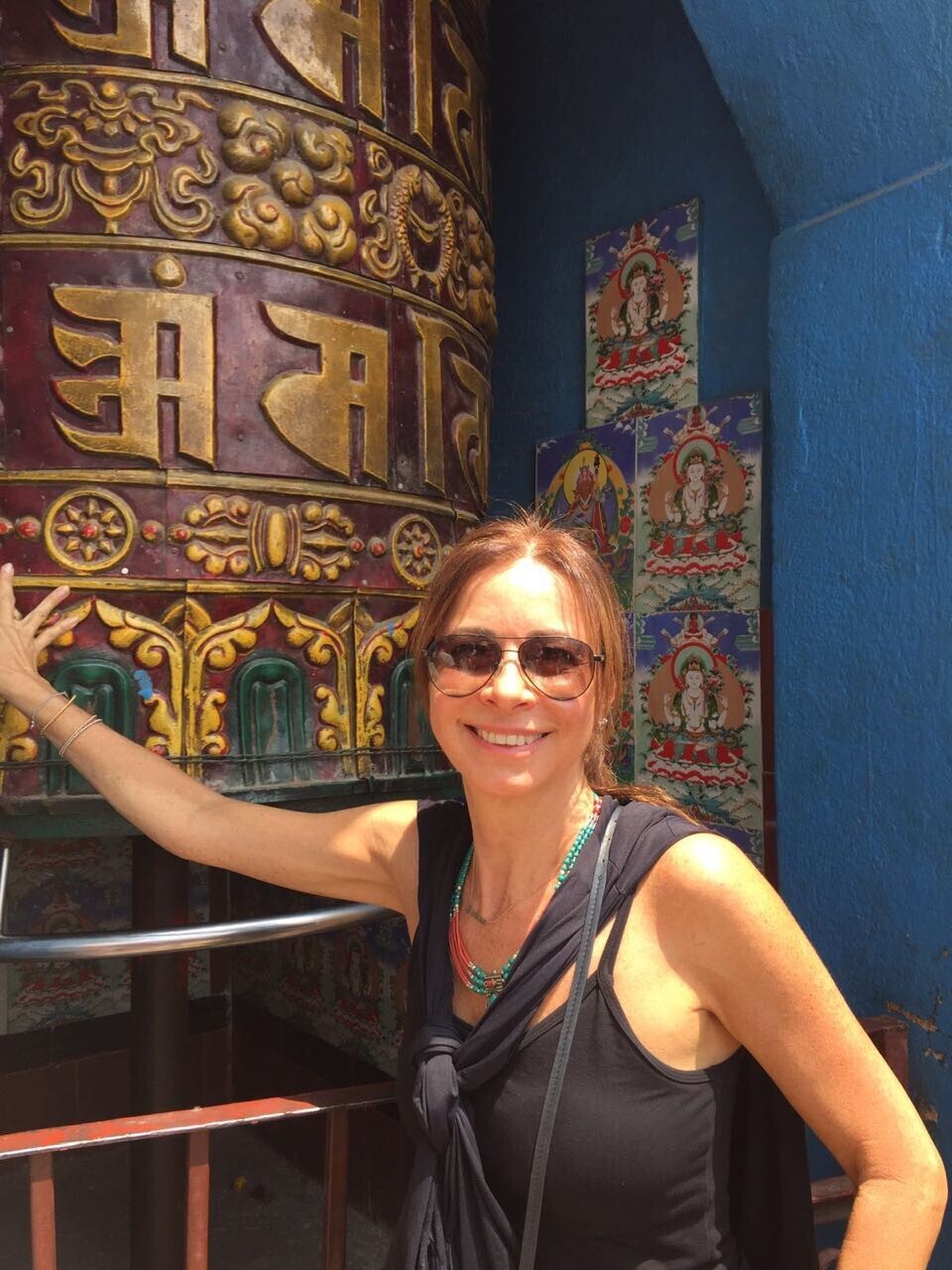 Spinning a huge prayer wheel while enjoying a city tour of Kathmandu, included in the Luxury Everest Base Camp Trek.