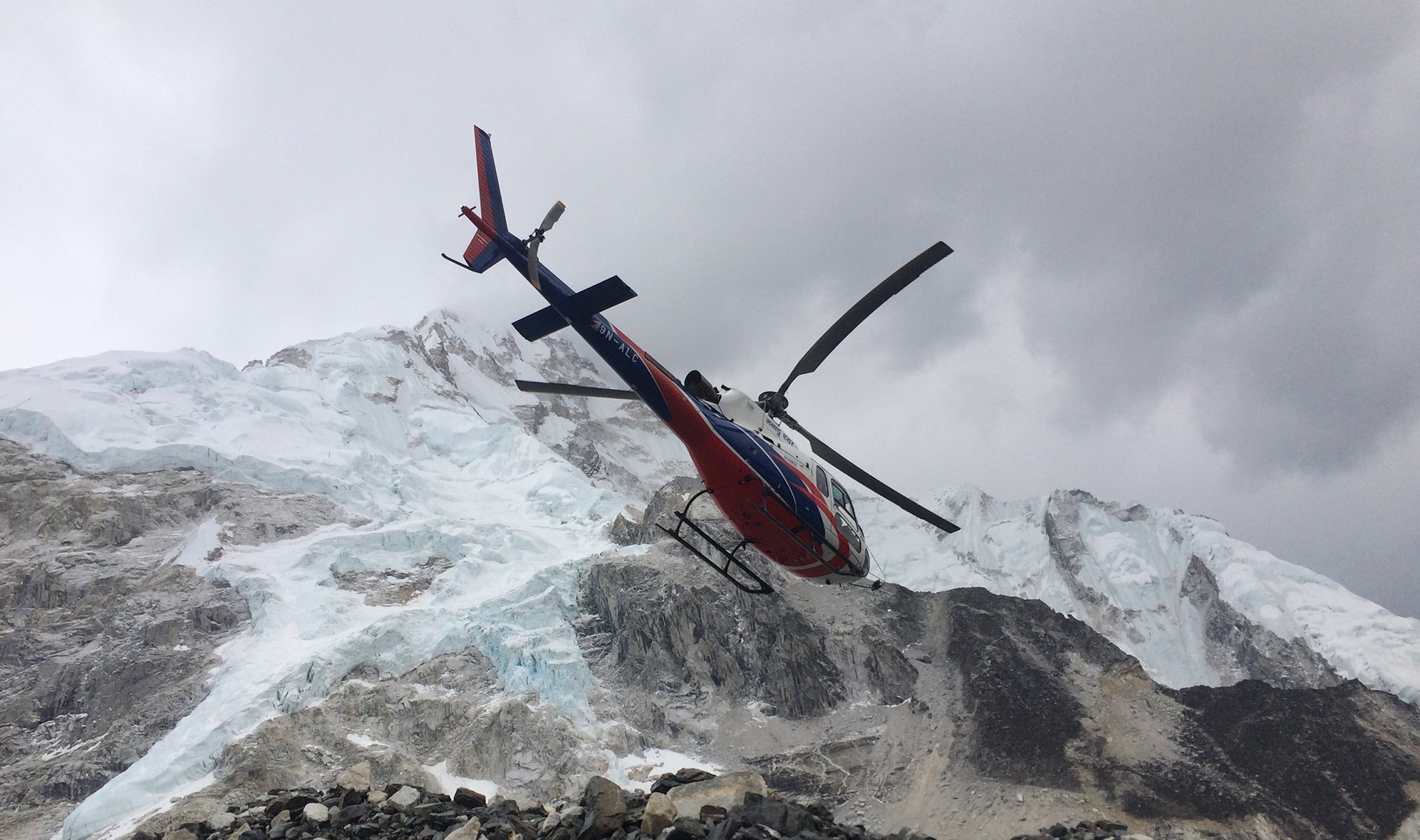 A helicopter takes off from Everest Base Camp.