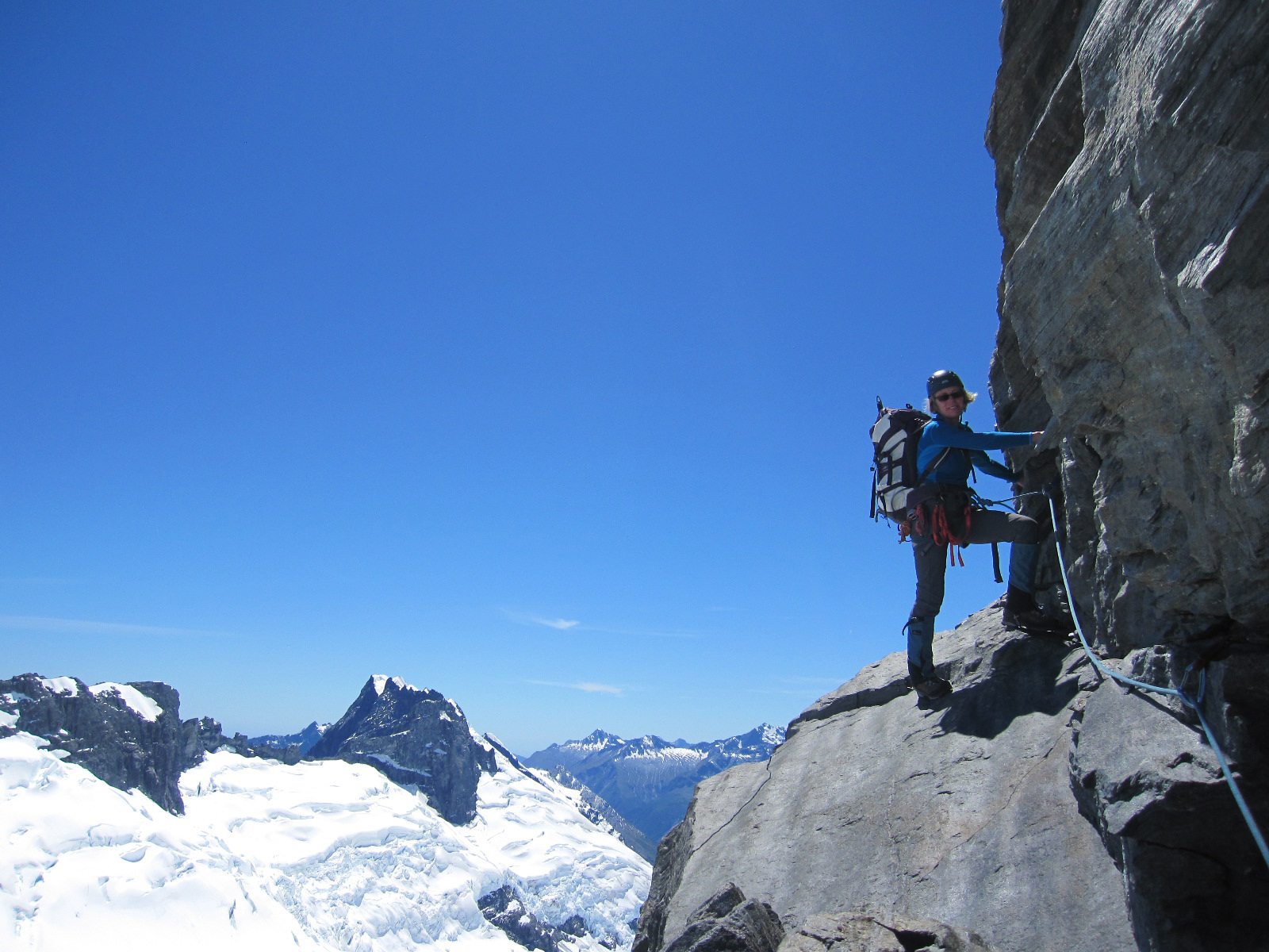 Traversing a steep rocky face on the North West Ridge of New Zealand's Mount Aspiring.