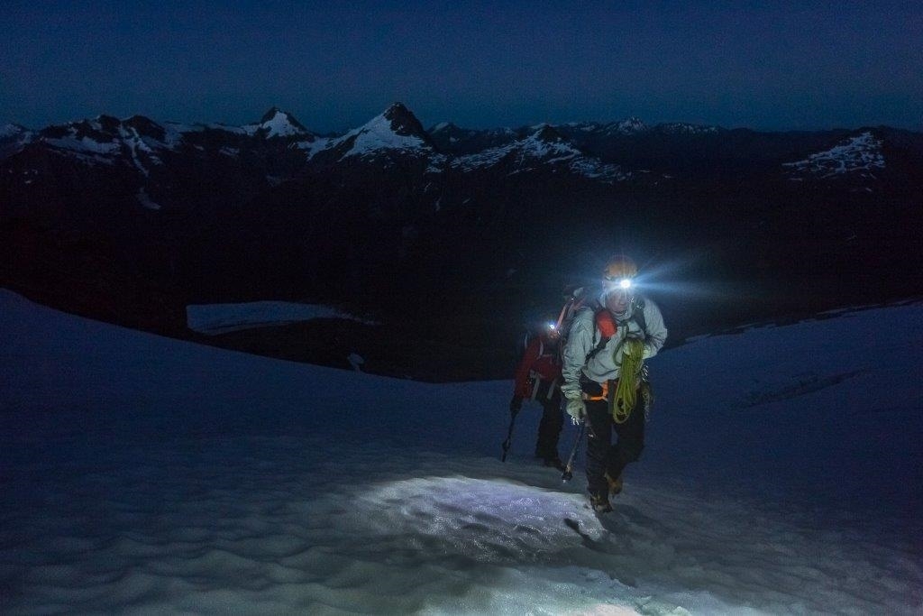 A climber departs in the early hours of the morning to climb a peak