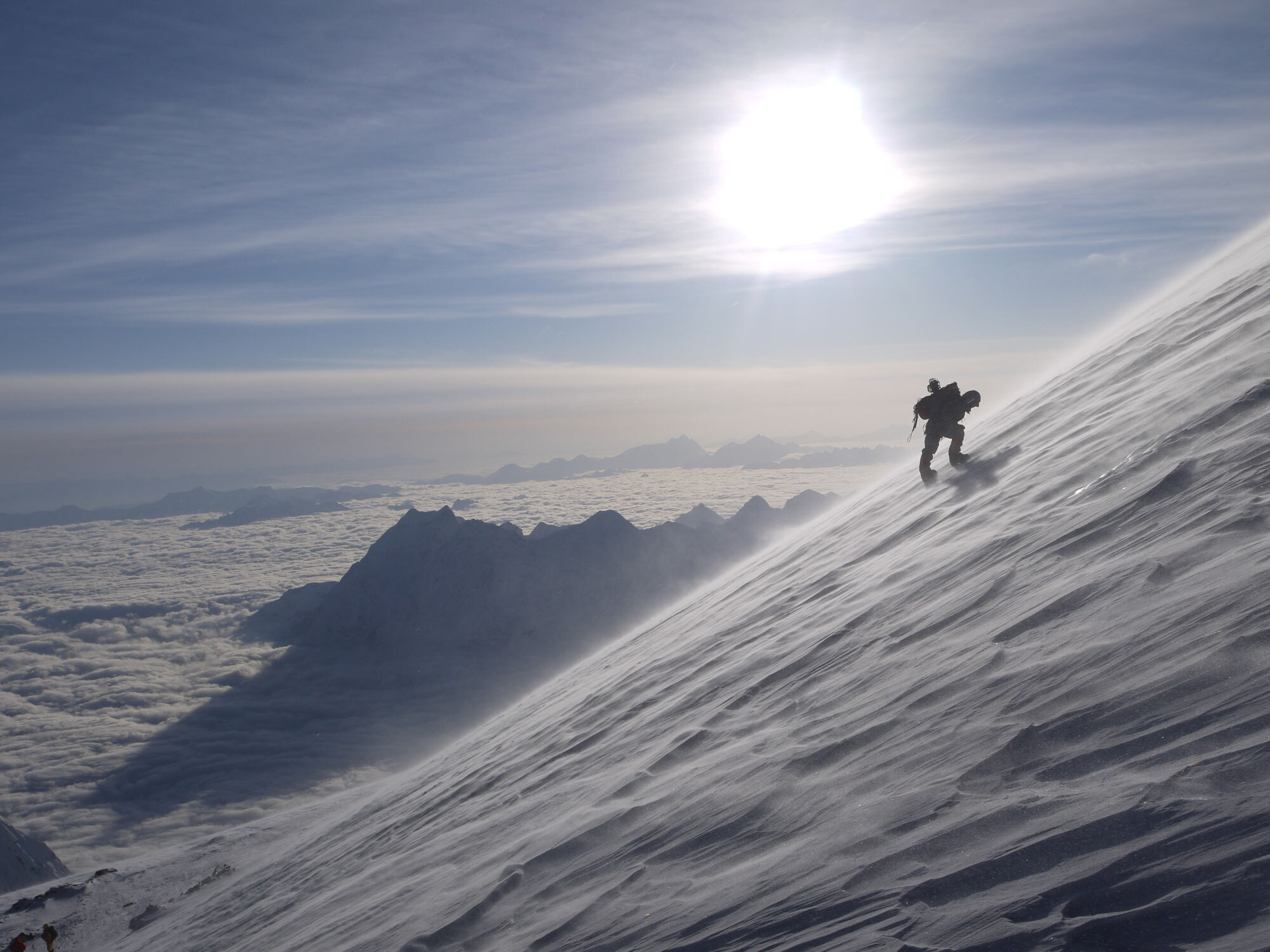 Summit day on Manaslu, pushing above Camp 4 as the sun rises over a sea of clouds