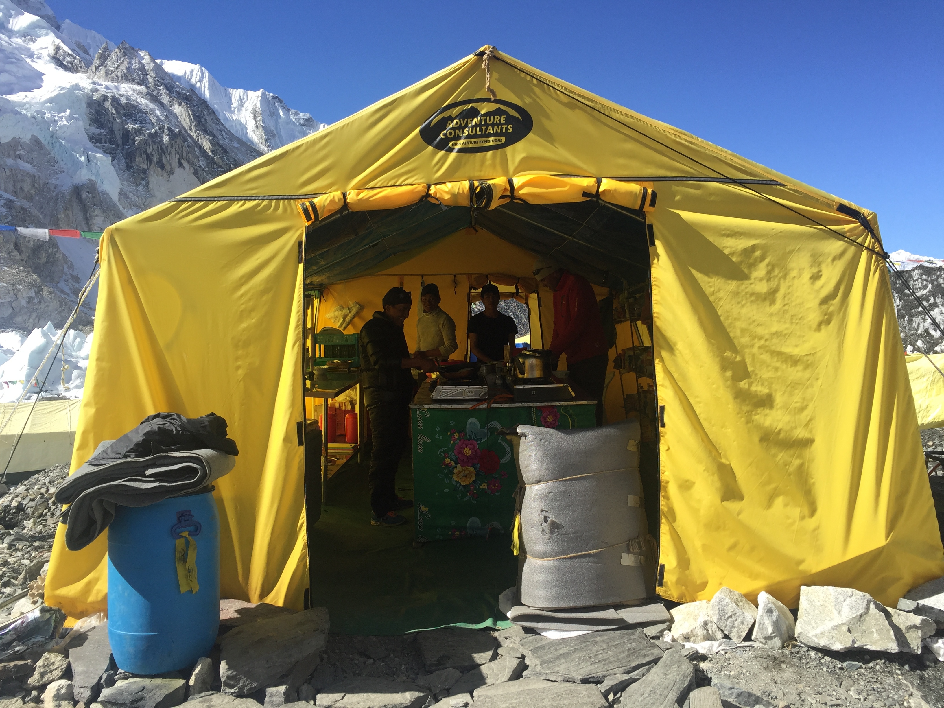 The bright yellow Adventure Consultants kitchen tent, where magic happens on the side of a mountain!