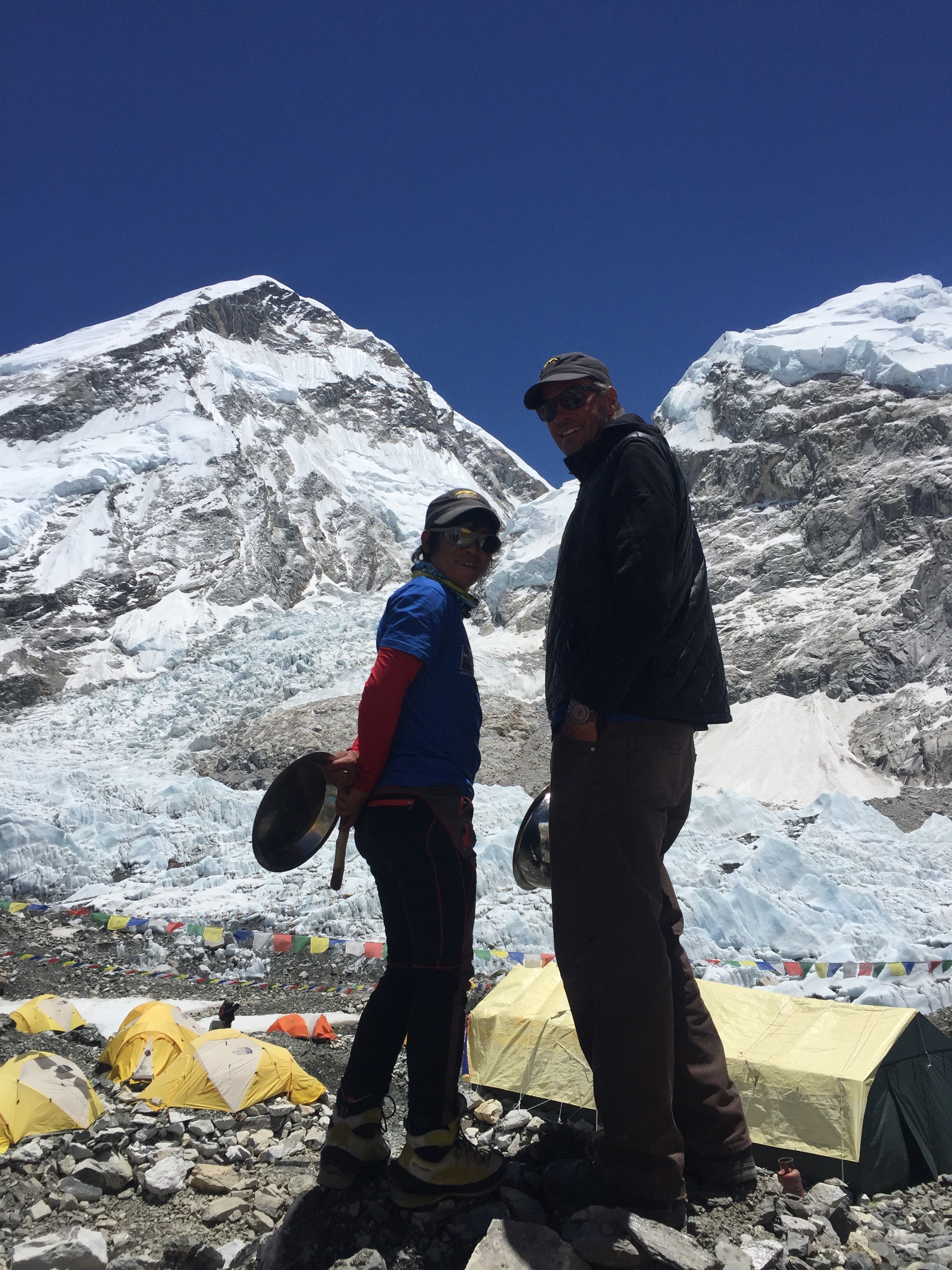 Tilak Rai and James ready to welcome the Everest climbers back into Base Camp, holding pots to bang together loudly in what is now a traditional welcome back!
