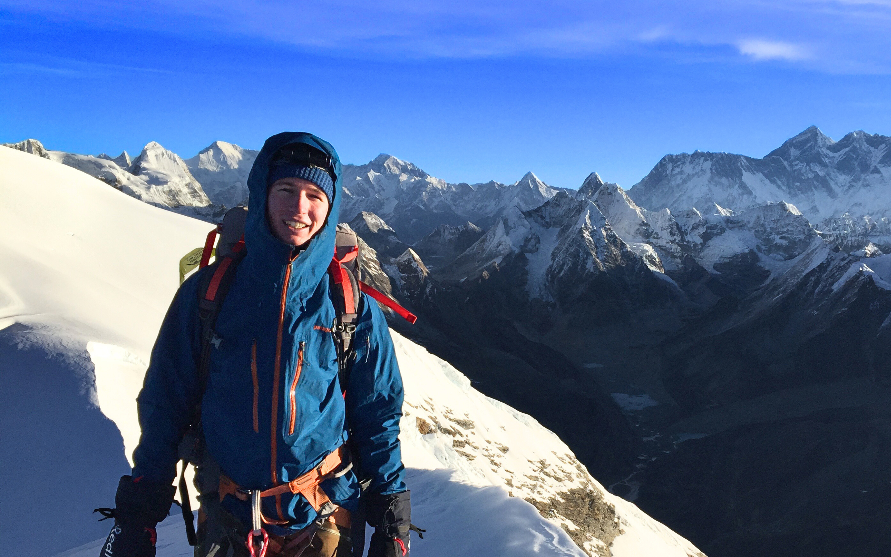 Summit of peak Mera. Person standing Infront of the mountain