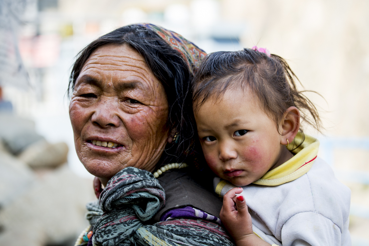 A grandmother carries her grandchild in Kagbeni, Nepal