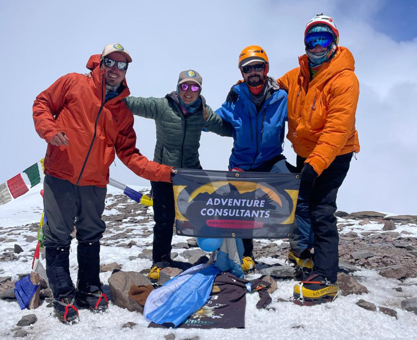 AC's Aconcagua Expedition Team #2 2025 stands atop of South America's highest peak in snowy conditions.