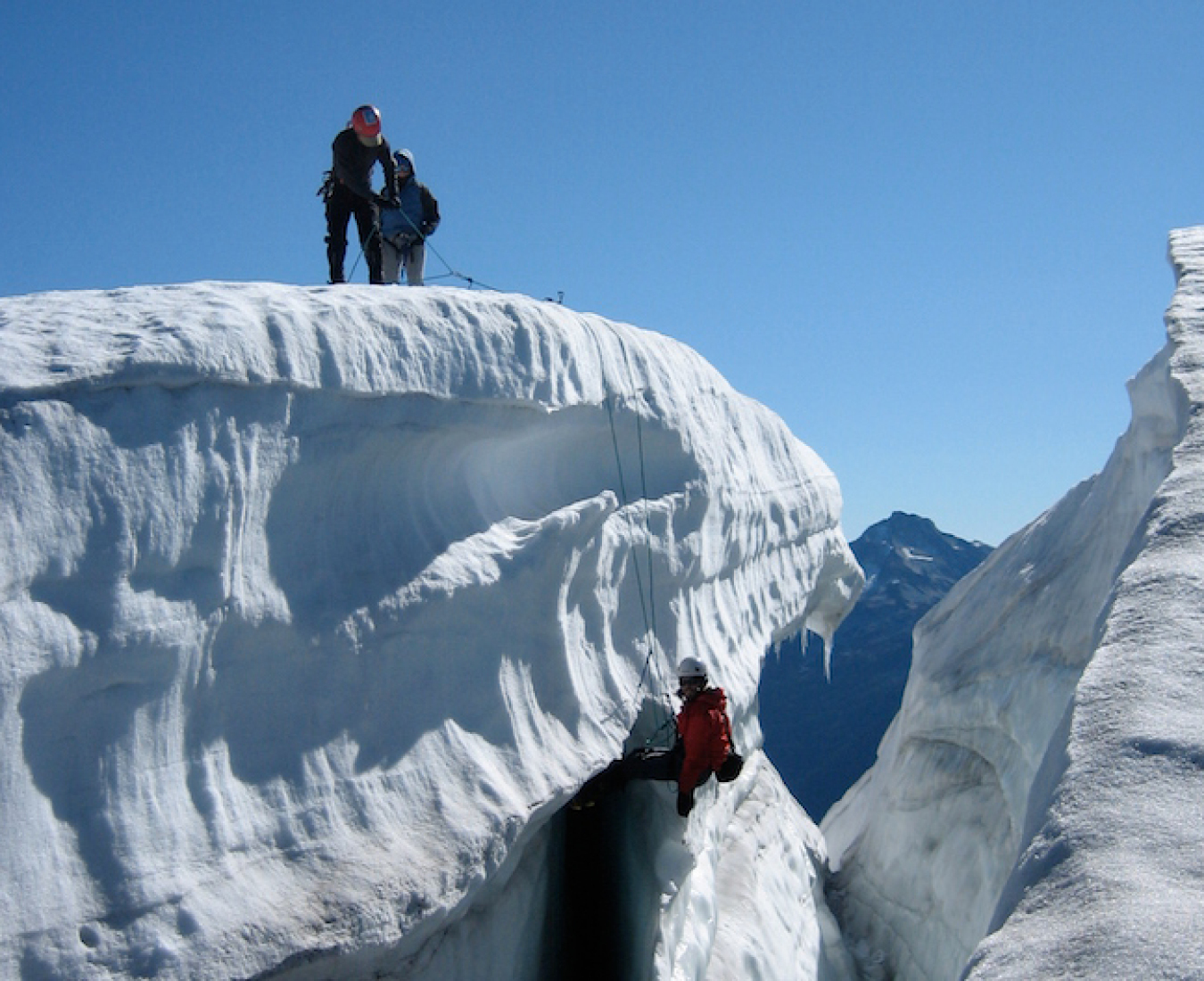 Putting new skills into practice in the mountains, a team practice crevasse rescue, pulling their companion out of a deep crevasse.