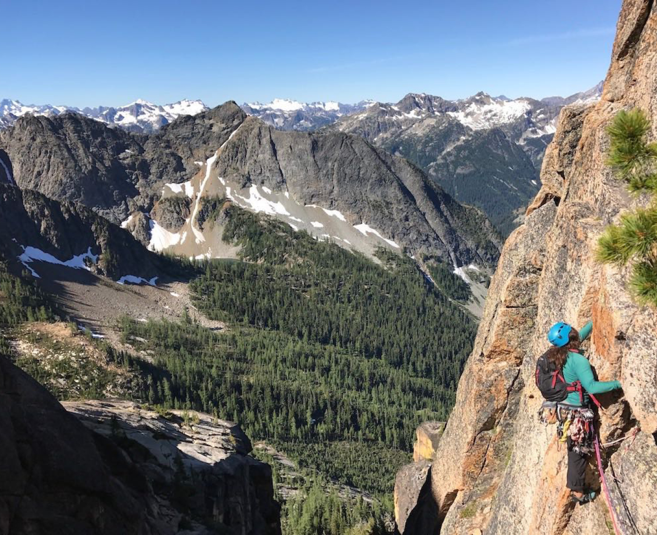 A climber ascends the classic Liberty Bell, with the expansive Washington mountains in the distance. Photo by AAI