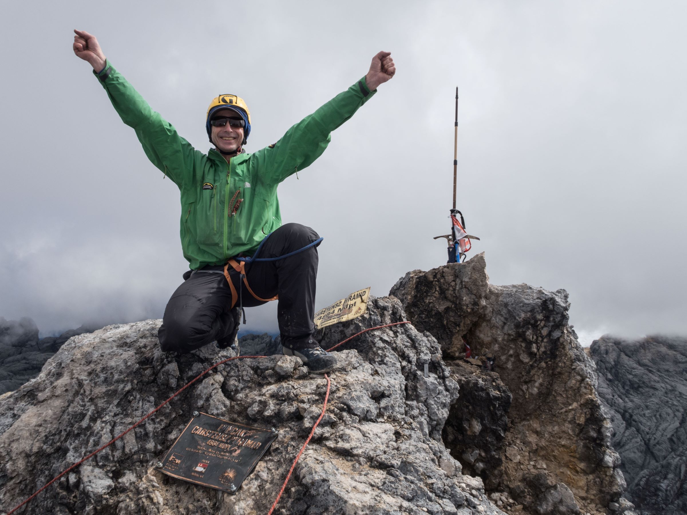 Climber ecstatic on summit of Carstensz