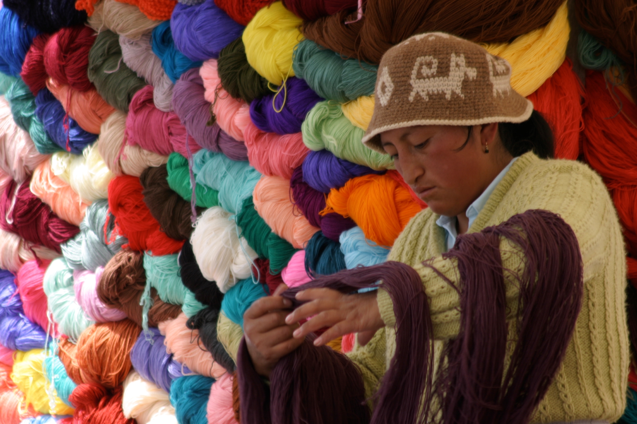 A local women with brightly coloured yarn at a market