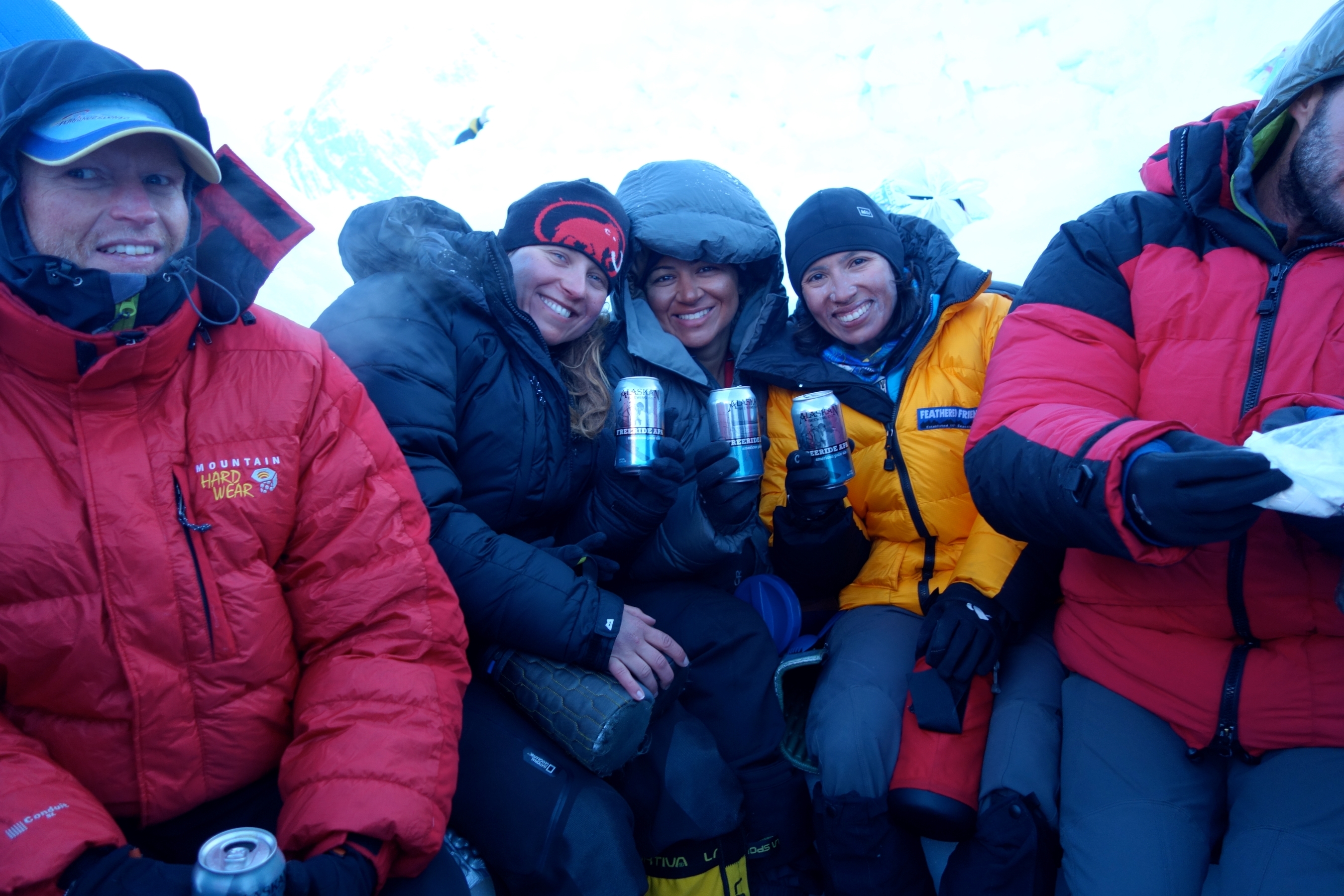 A team all smiles back at camp after a successful summit of Denali.