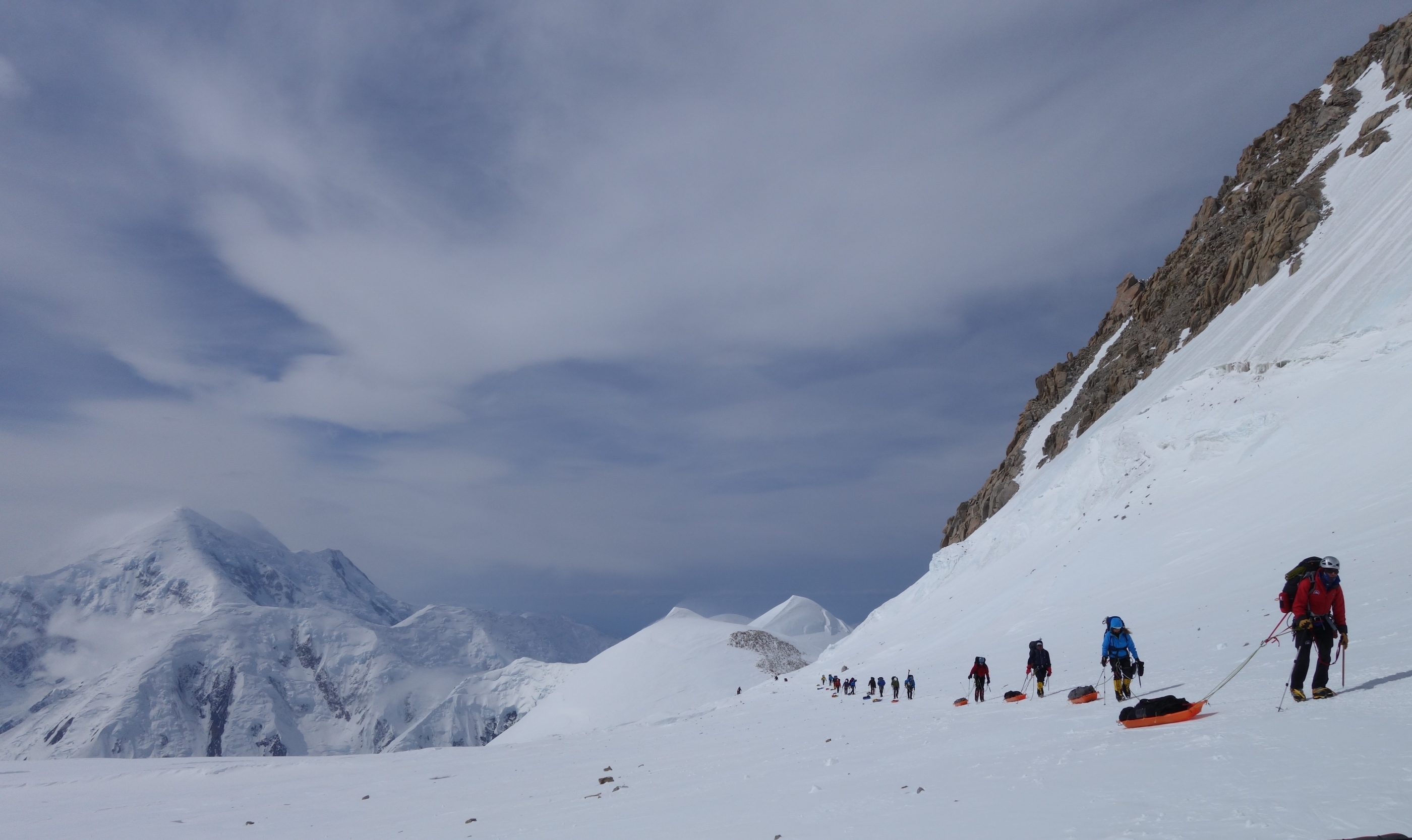 A team pulls sleds on the lower Kahiltna Glacier, Denali.