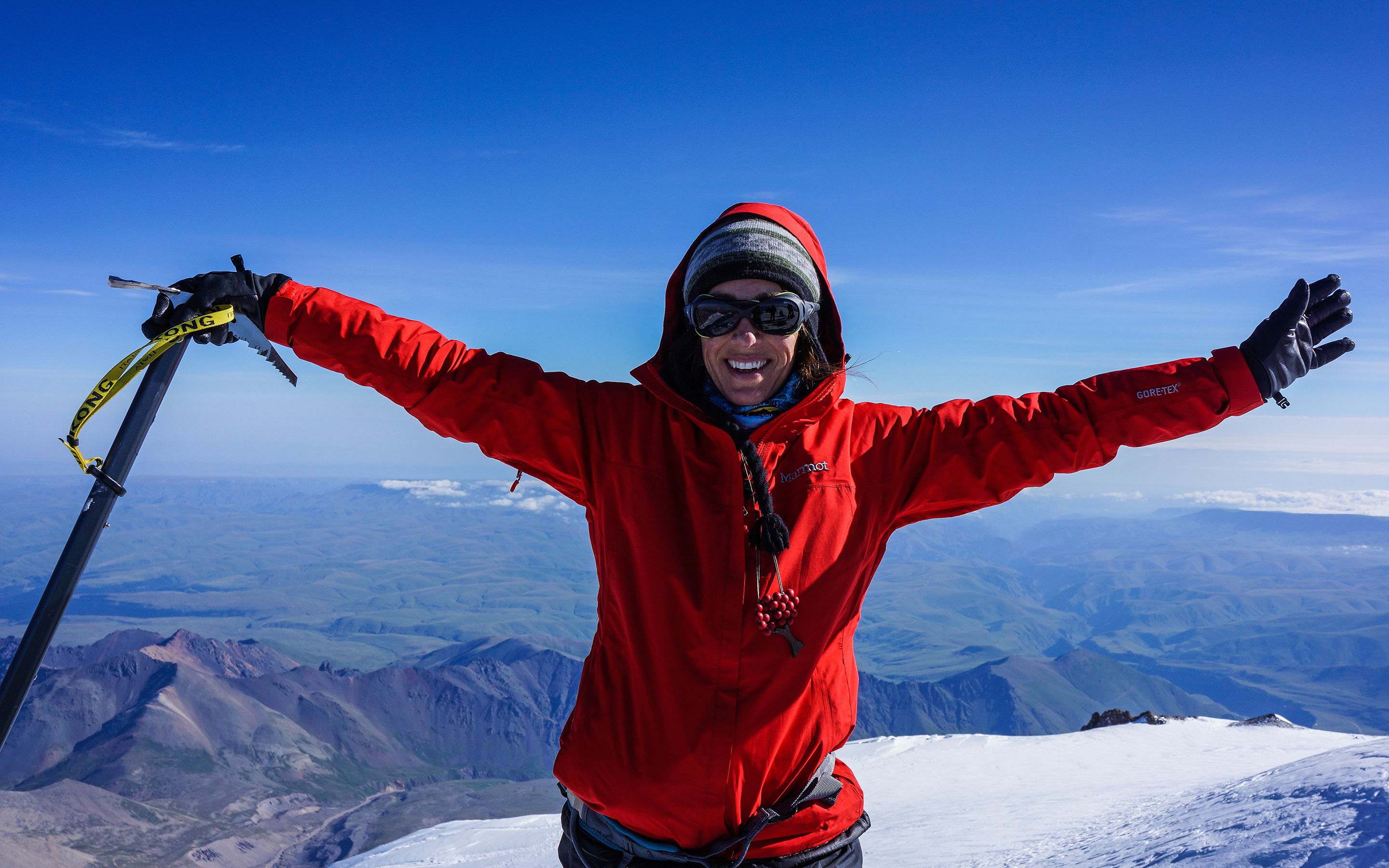 A climber celebrates on the summit of Europe's highest peak, Elbrus.