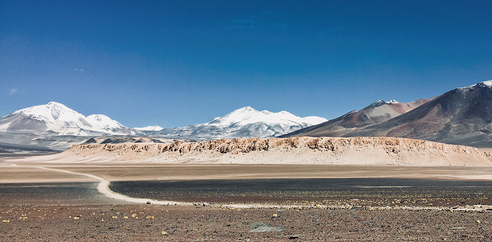 View across the Atacama plateau to Ojos del Salado the world's highest volcano.